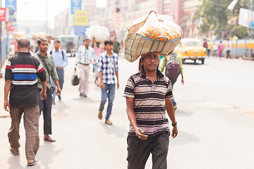 Image showing Man carrying flowers