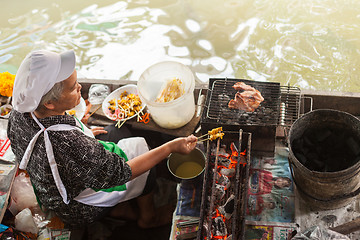 Image showing Woman preparing Thai kebab