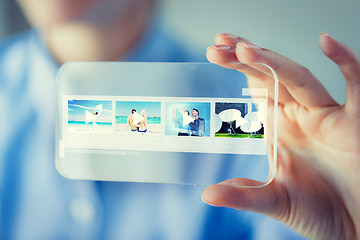 Image showing close up of woman with transparent smartphone