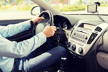 Image showing close up of young man driving car