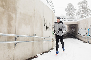 Image showing man running out of subway tunnel in winter