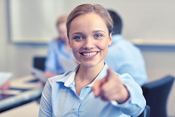 Image showing smiling businesswoman pointing finger on you