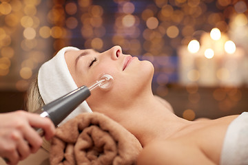 Image showing close up of young woman having face massage in spa