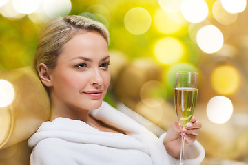 Image showing beautiful young woman drinking champagne at spa