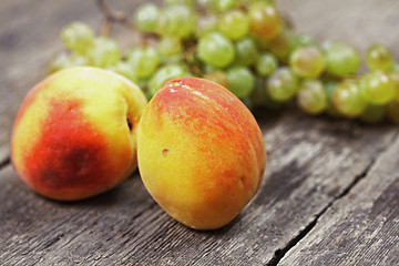 Image showing Two peaches and bunch of grapes
