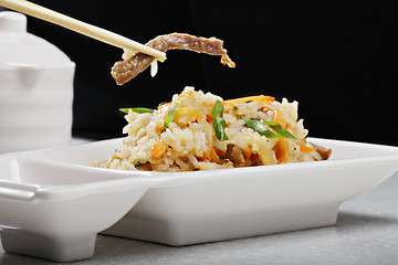 Image showing Vietnamese pilaf with beef in a chopsticks