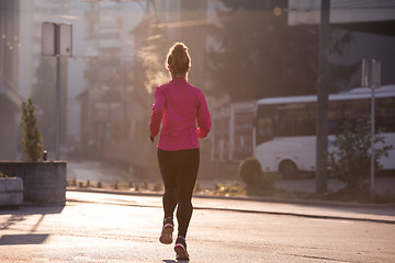 Image showing sporty woman jogging on morning