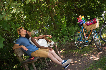 Image showing Young multiethnic couple having a bike ride in nature