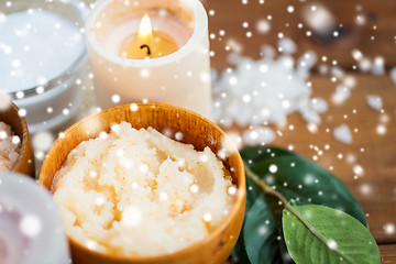 Image showing close up of natural body scrub and candle on wood