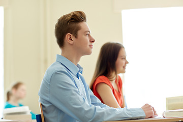 Image showing group of students with notebooks at school lesson