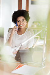 Image showing businesswoman calling on smartphone at office