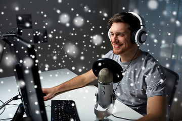 Image showing man in headset playing computer video game at home