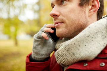 Image showing close up of man with smartphone calling in autumn