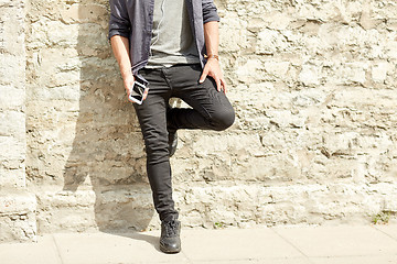 Image showing man with earphones and smartphone on street