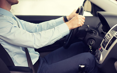 Image showing close up of young man driving car