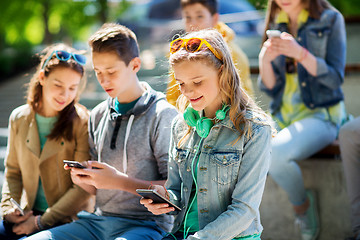 Image showing happy teenage girl with smartphone and headphones