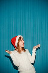 Image showing Surprised christmas girl wearing a santa hat