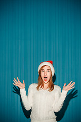 Image showing Surprised christmas girl wearing a santa hat