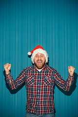 Image showing Smiling christmas man wearing a santa hat