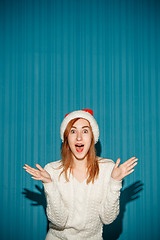 Image showing Surprised christmas girl wearing a santa hat