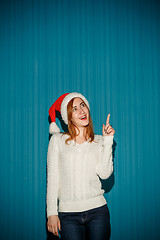 Image showing Surprised christmas girl wearing a santa hat