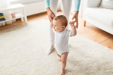 Image showing happy baby learning to walk with mother help
