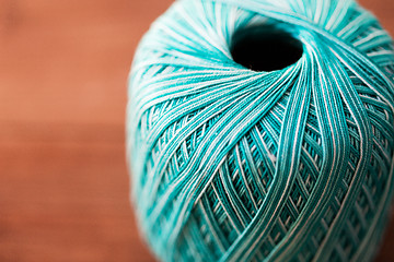 Image showing close up of turquoise knitting yarn ball on wood
