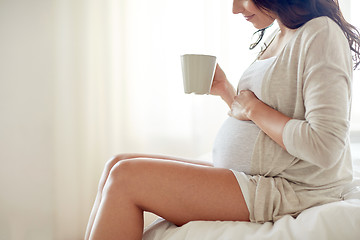 Image showing close up of pregnant woman with tea cup at home