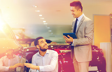 Image showing happy man with car dealer in auto show or salon