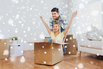 Image showing happy couple having fun with boxes at new home