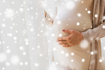 Image showing close up of pregnant woman belly and hands