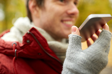 Image showing close up of man recording voice on smartphone
