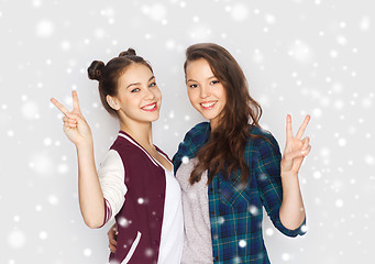 Image showing happy teenage girls hugging and showing peace sign