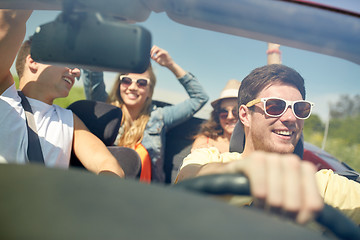 Image showing happy friends driving in cabriolet car