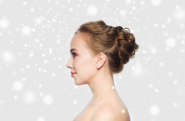 Image showing beautiful young woman face over snow