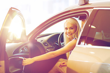 Image showing happy woman inside car in auto show or salon
