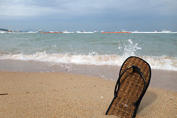 Image showing Beach slippers on a sandy beach