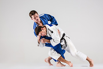 Image showing The two judokas fighters fighting men