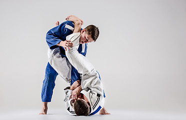 Image showing The two judokas fighters fighting men