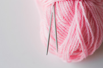 Image showing close up of knitting needles and pink yarn ball 