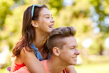 Image showing happy teenage couple having fun at summer park