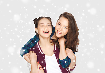 Image showing happy smiling teenage girls hugging over snow