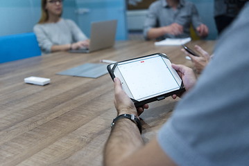 Image showing close up of businessman on meeting using tablet