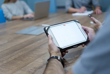 Image showing close up of businessman on meeting using tablet