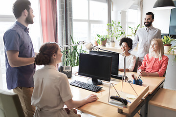 Image showing happy creative team talking in office