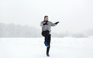 Image showing man exercising and warmig up in winter outdoors