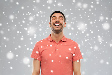 Image showing happy laughing man over snow background