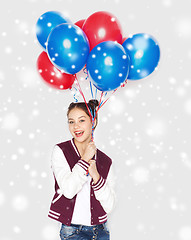 Image showing happy teenage girl with helium balloons over snow