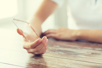 Image showing close up of woman with transparent smartphone