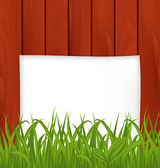 Image showing Paper sheet and green grass on wooden texture